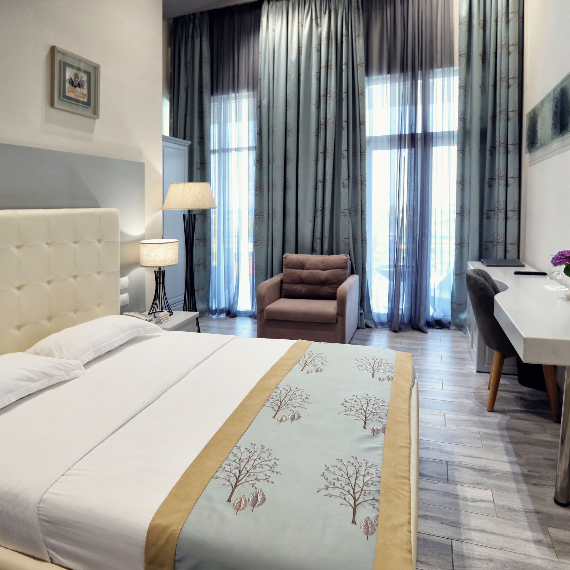 a bedroom with a bed and a chair and a desk