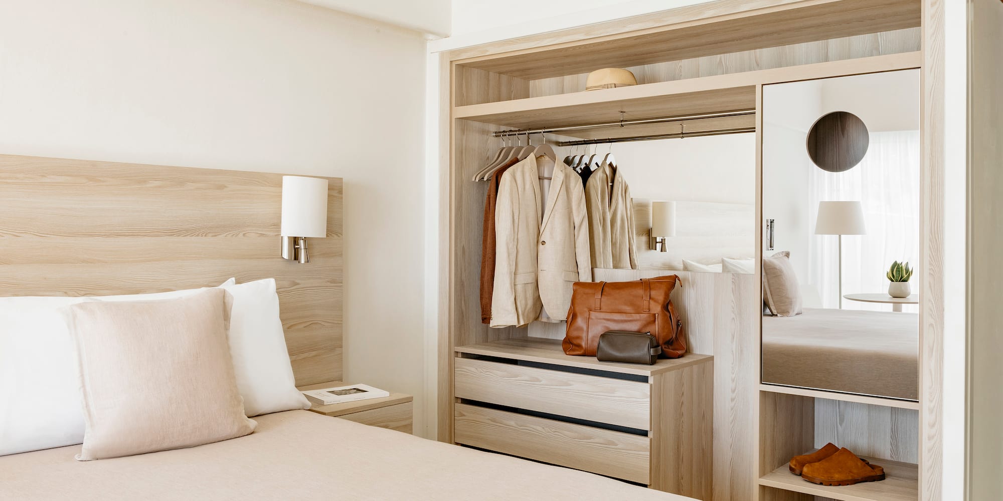 a room with a bed and a mirror