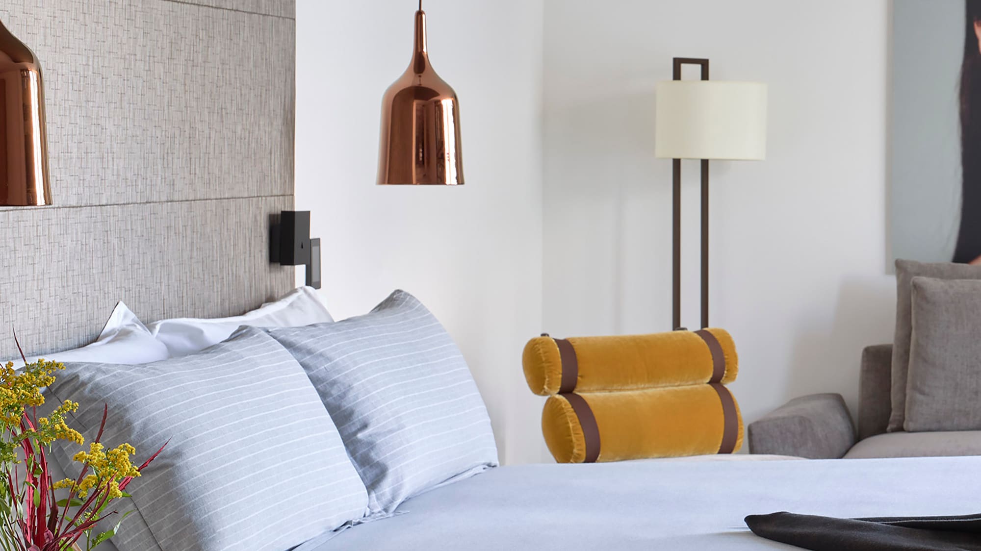 a bed with a vase of flowers