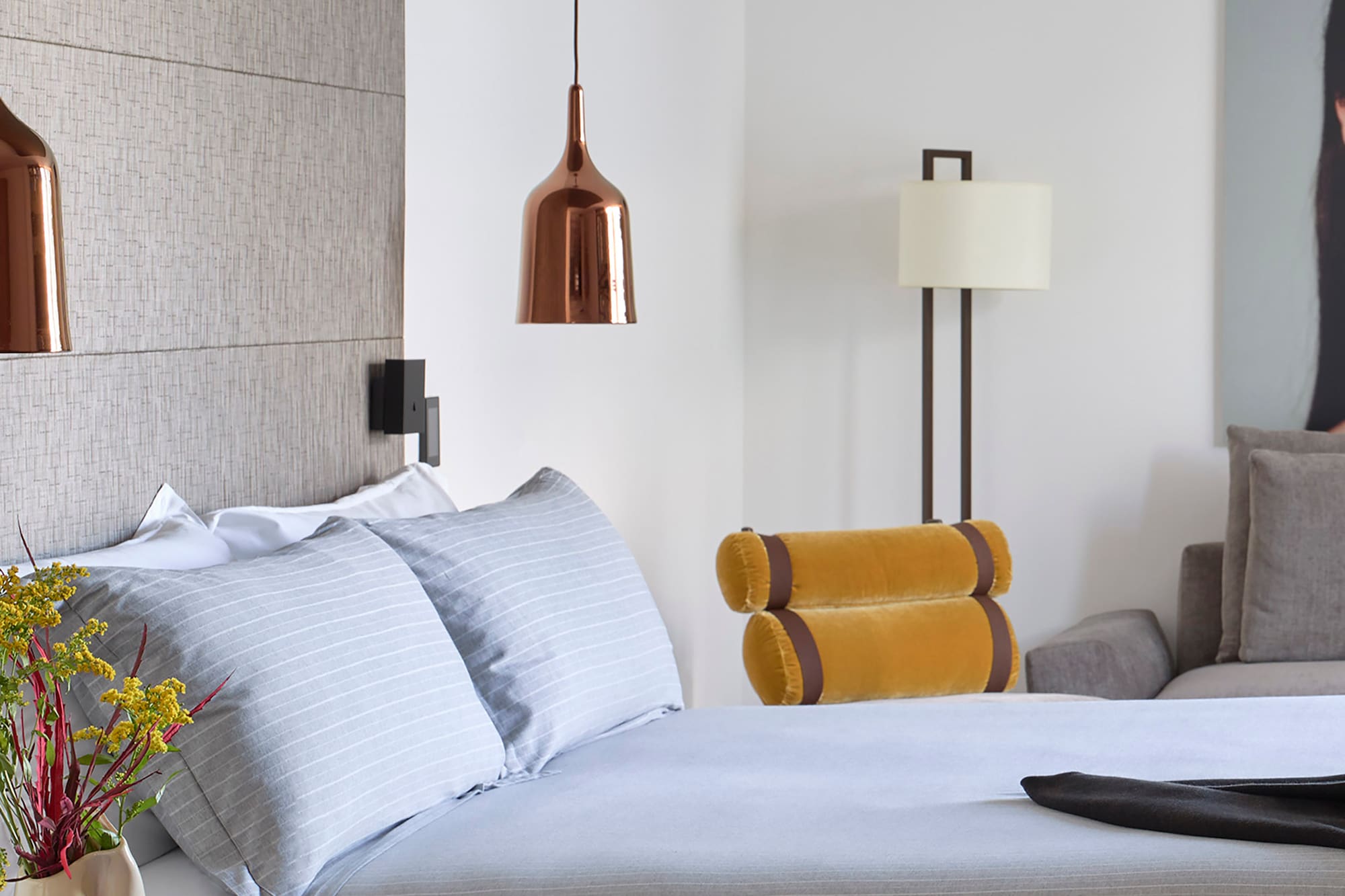 a bed with a vase of flowers