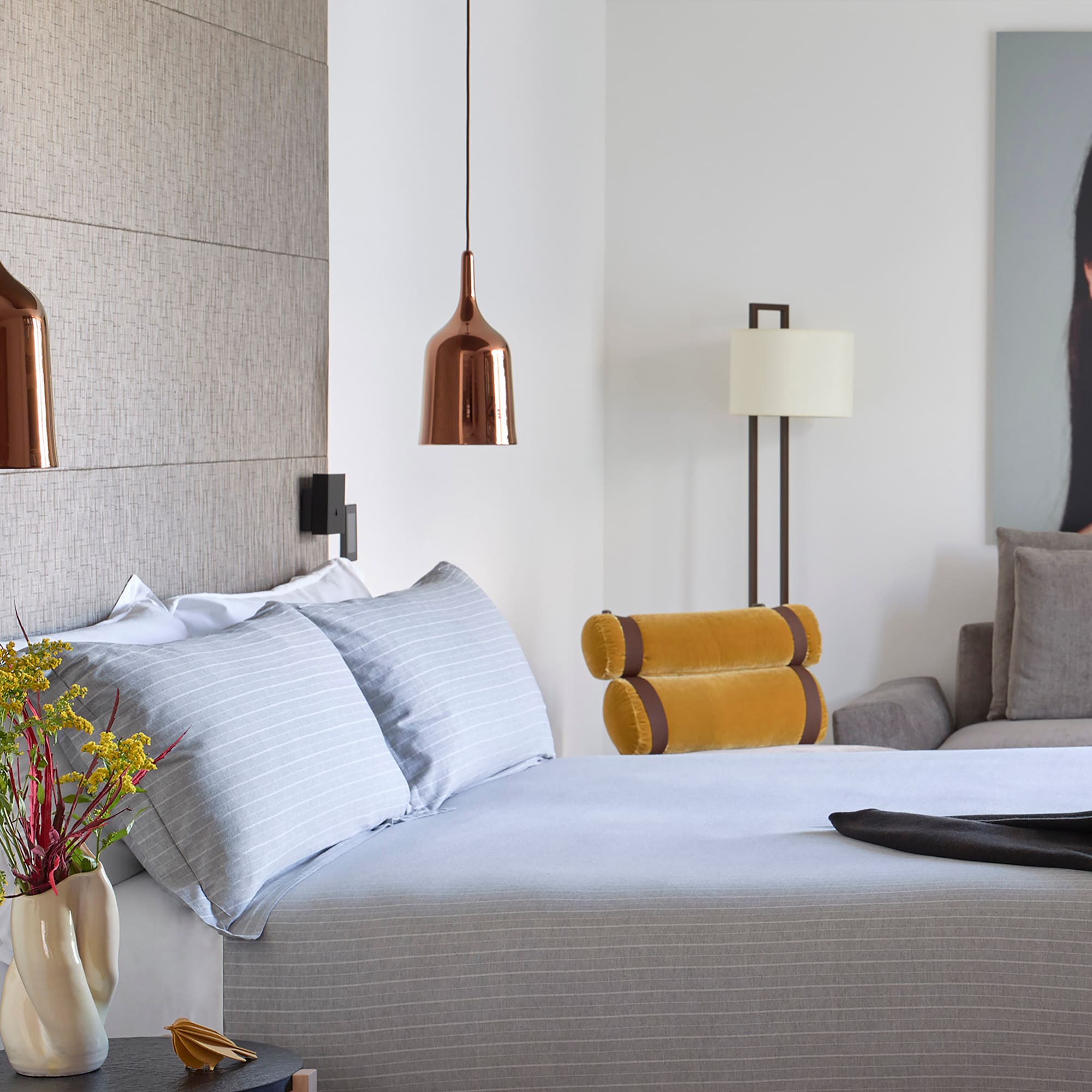 a bed with a vase of flowers