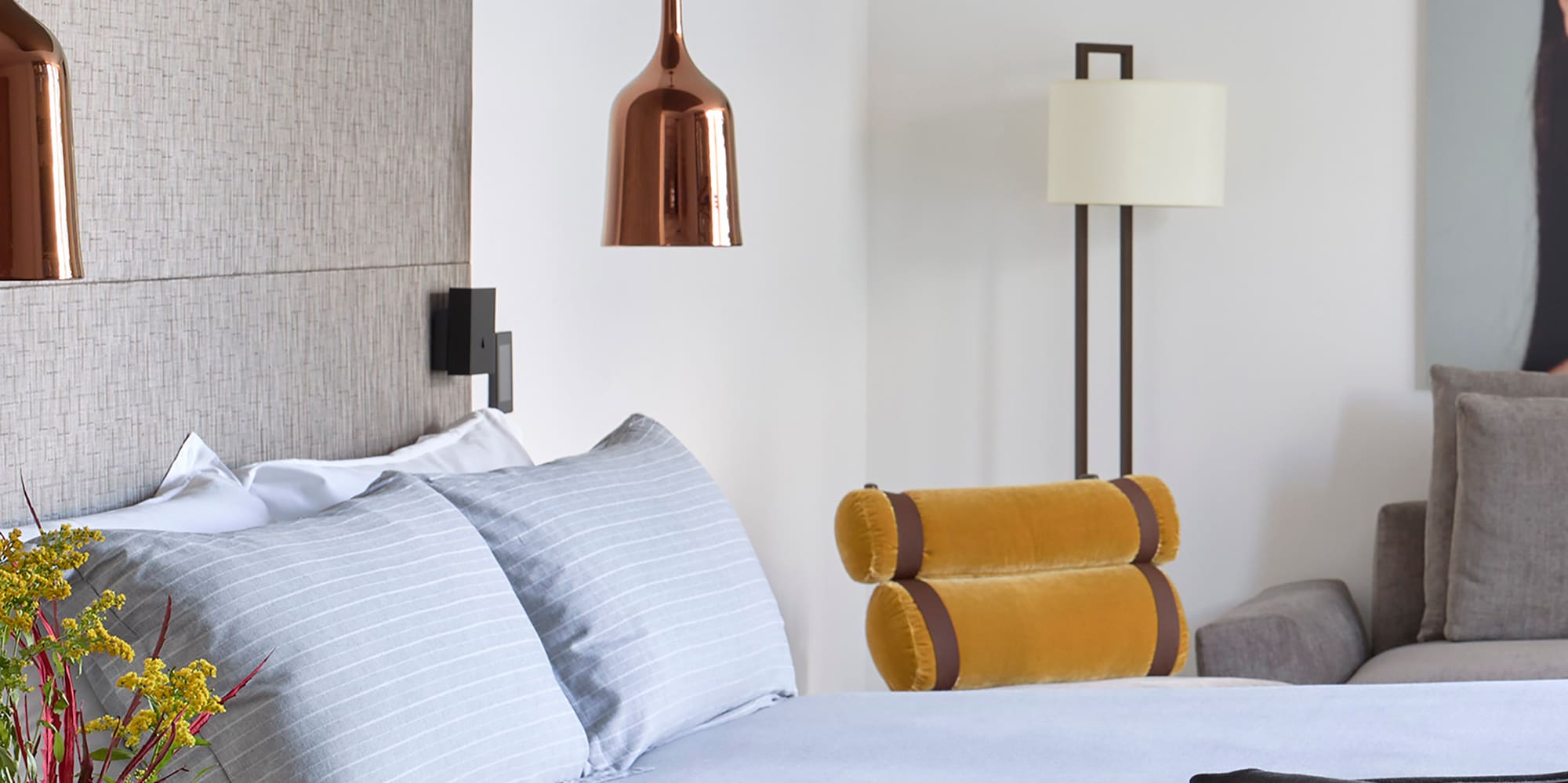 a bed with a vase of flowers