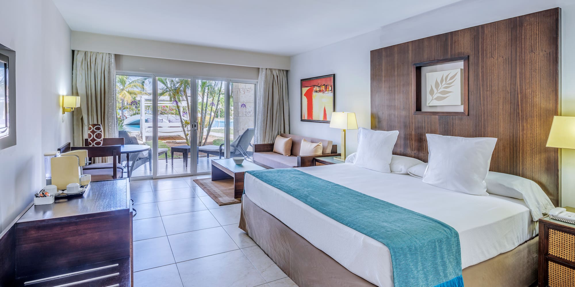 a room with a bed and a table and chairs