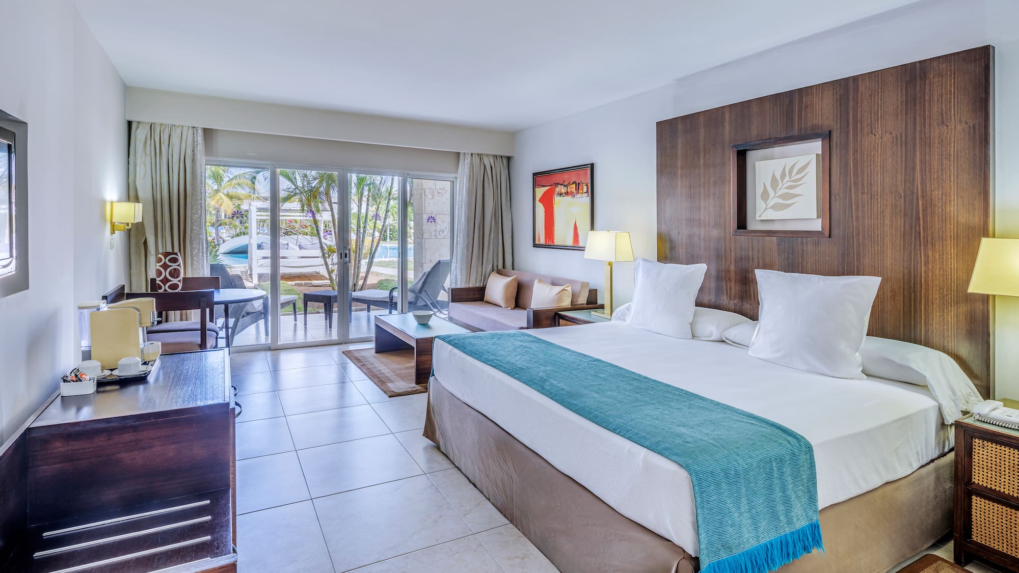 a room with a bed and a table and chairs