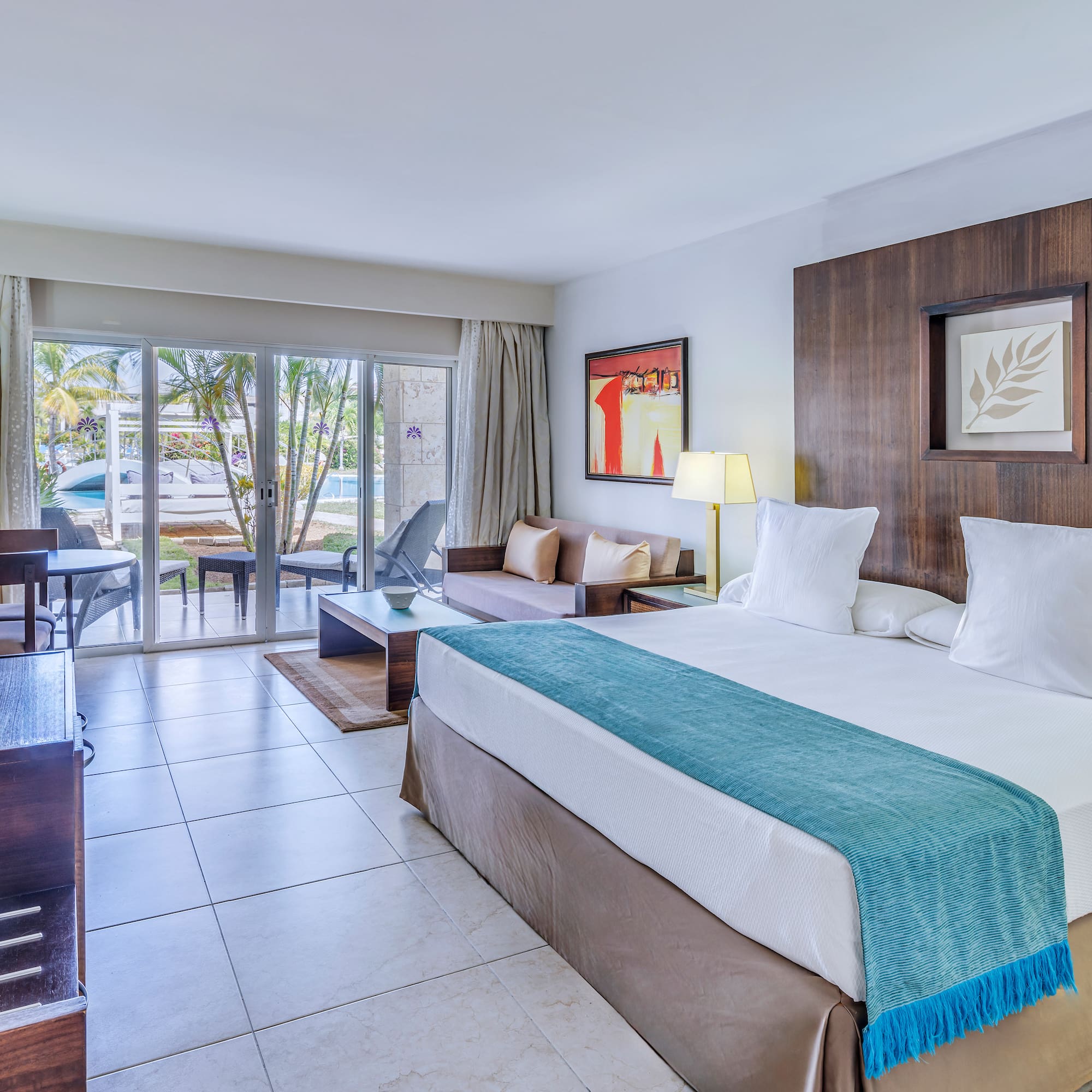 a room with a bed and a table and chairs