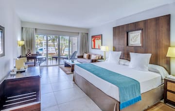 a room with a bed and a table and chairs