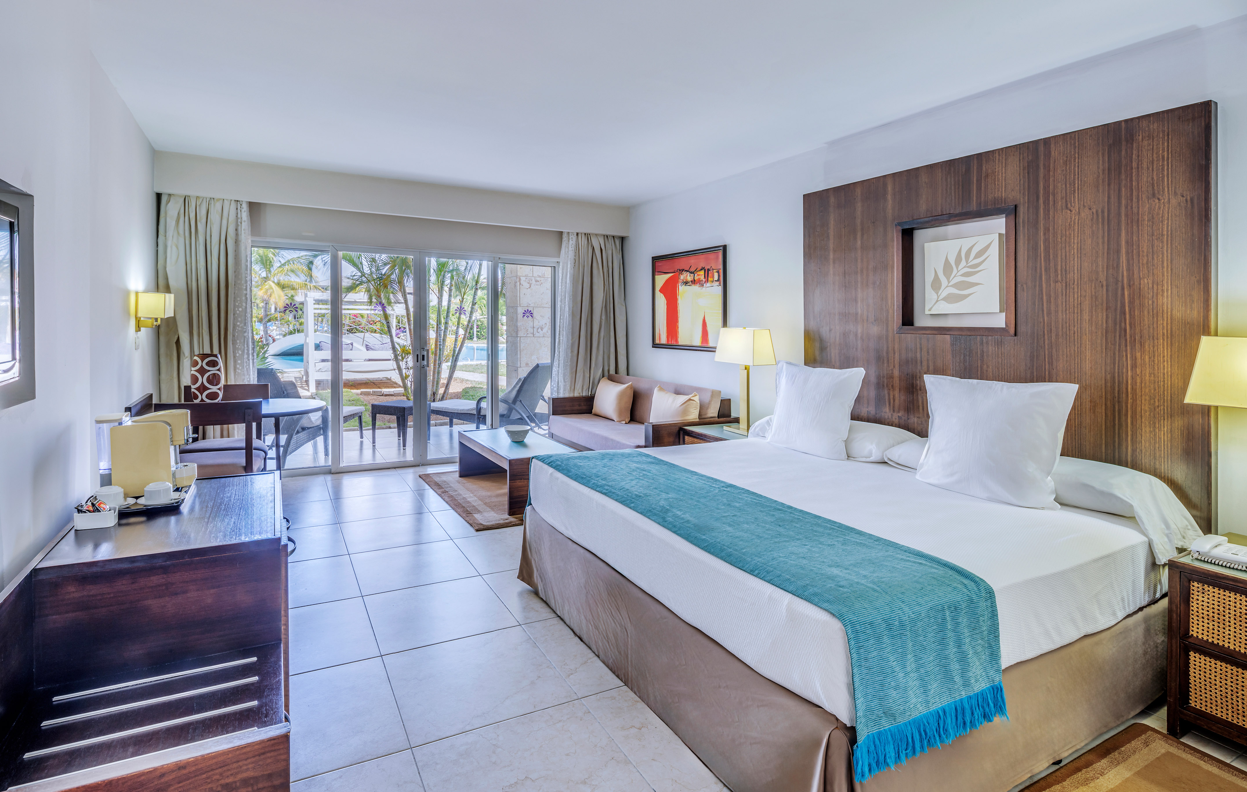 a room with a bed and a table and chairs