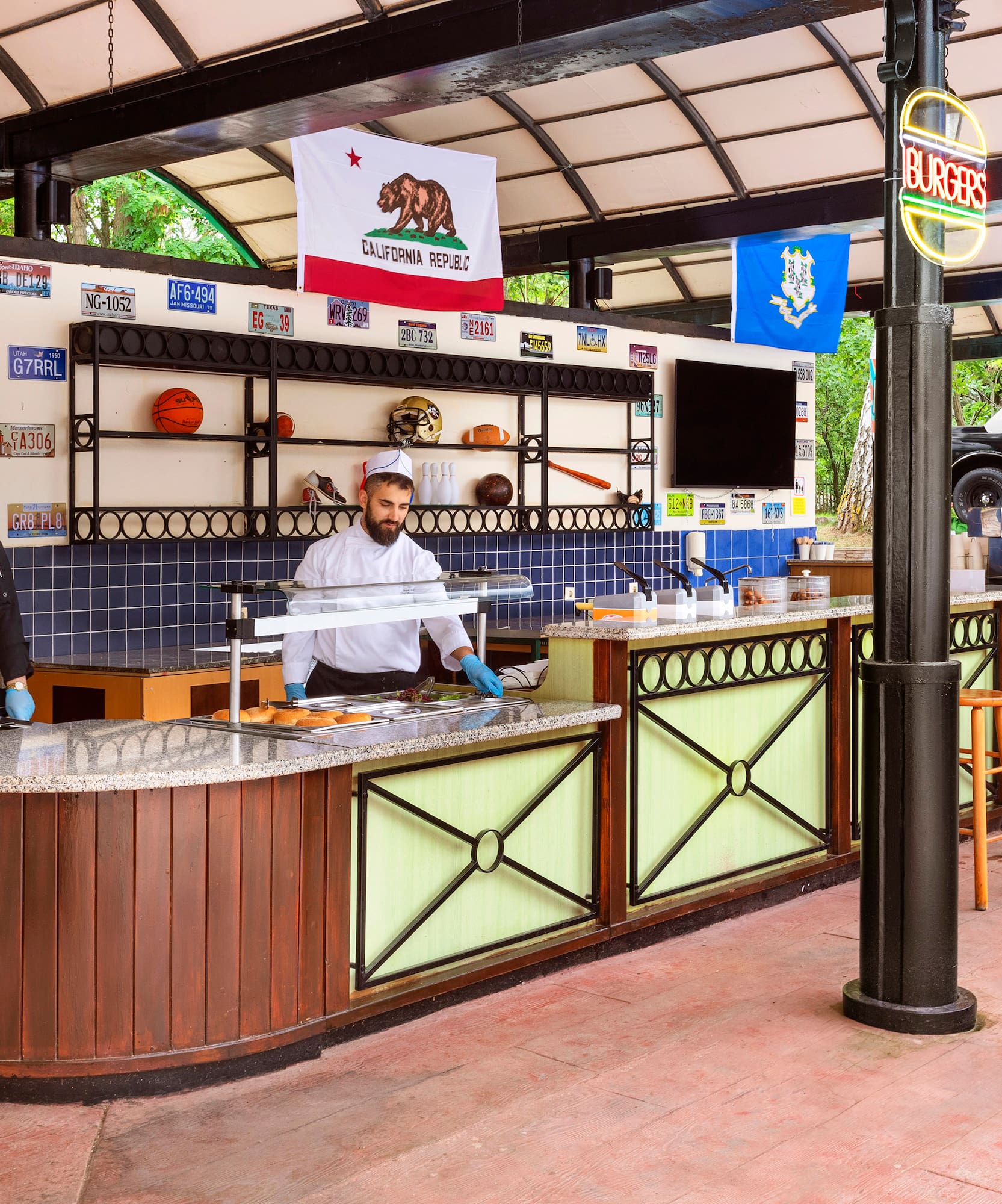 two men in chefs hats behind a counter