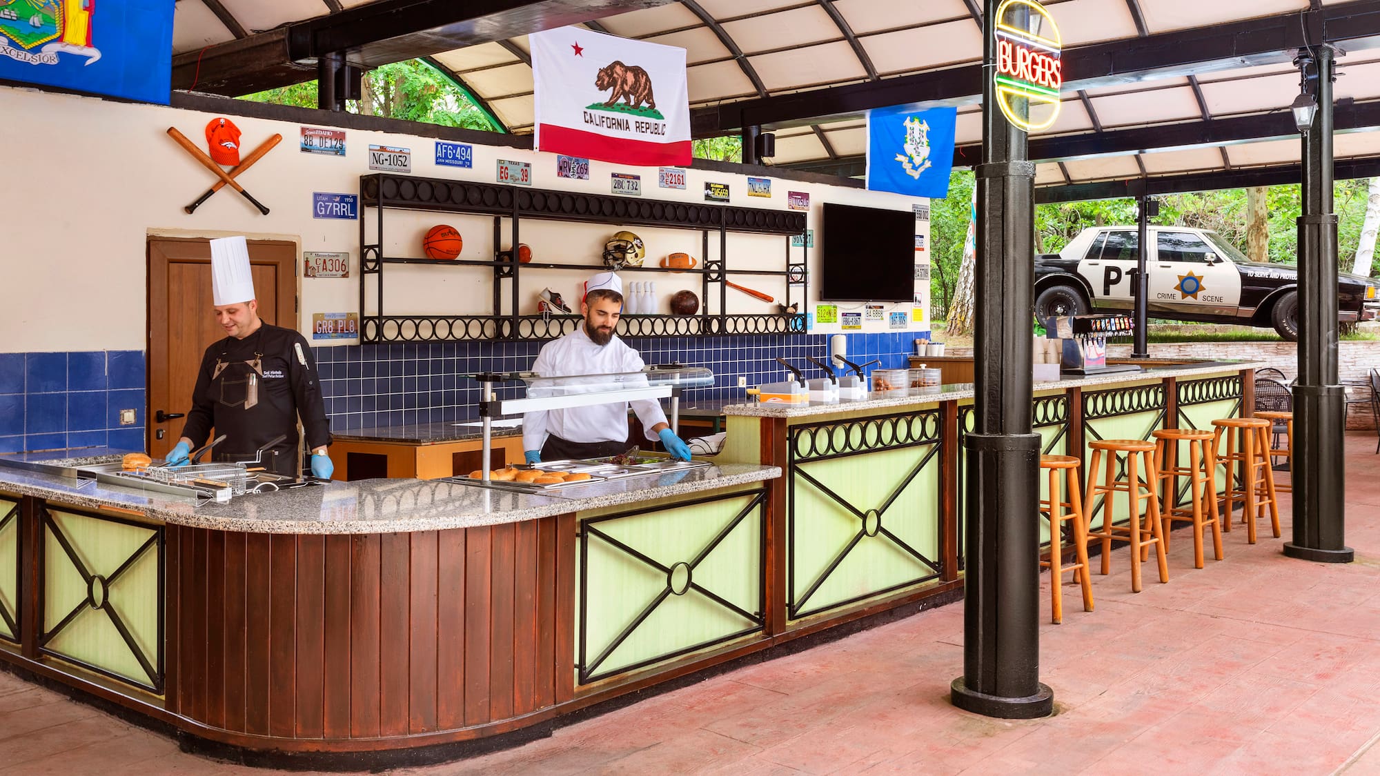 two men in chefs hats behind a counter