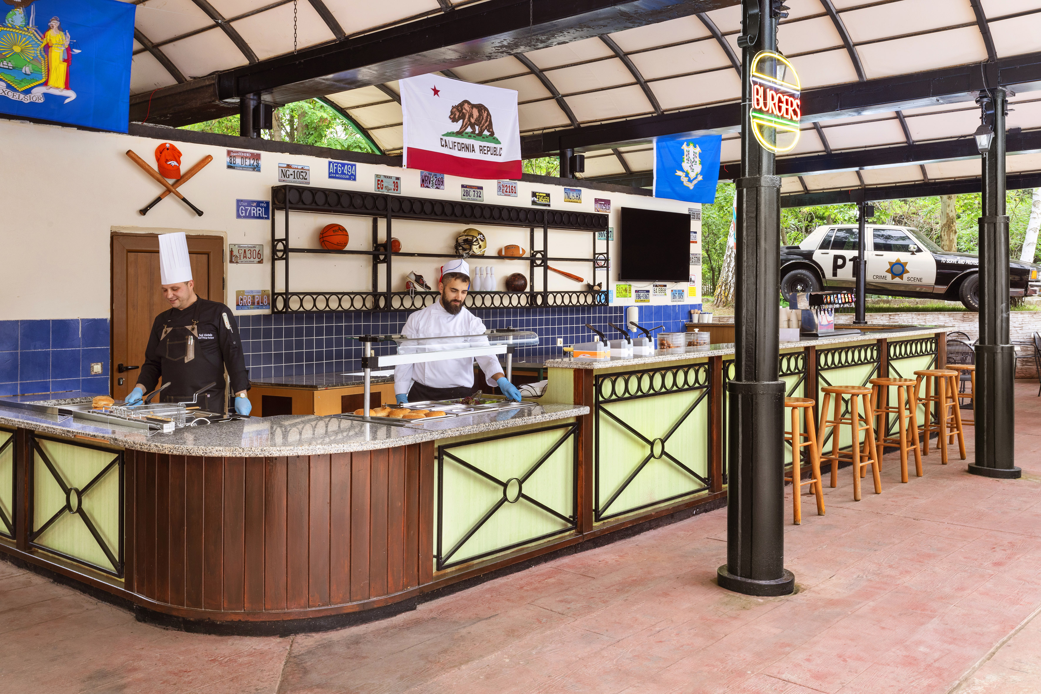 two men in chefs hats behind a counter