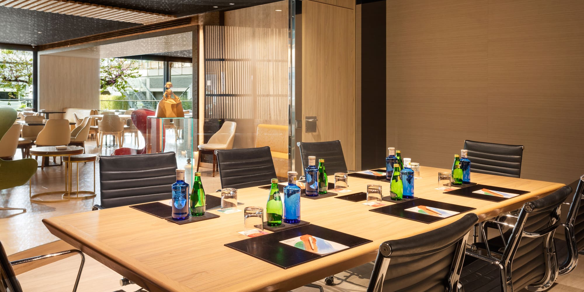 a conference room with a table with chairs and bottles of water