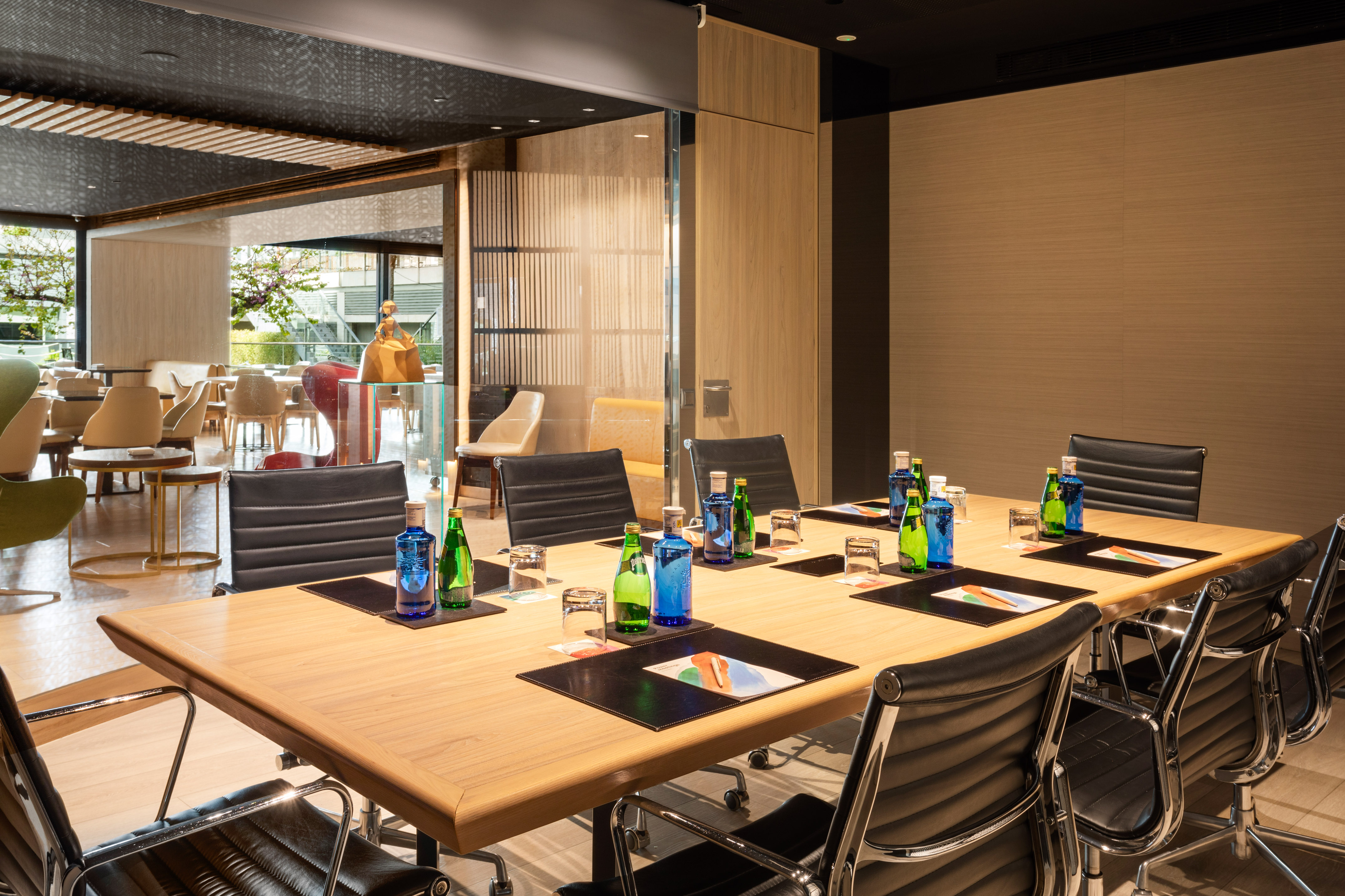 a conference room with a table with chairs and bottles of water