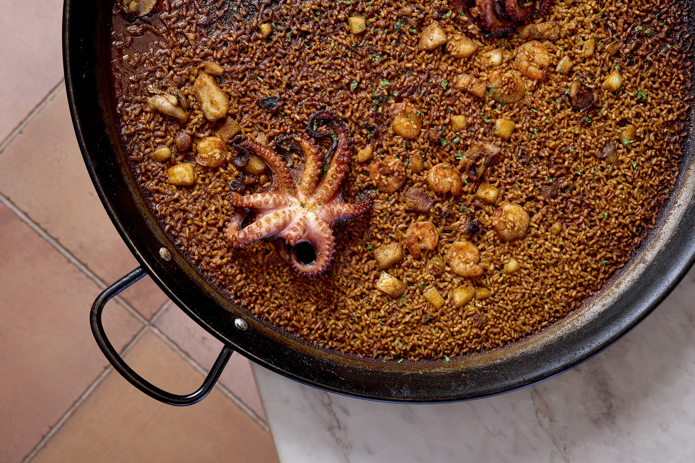 a pan of food with octopus on top