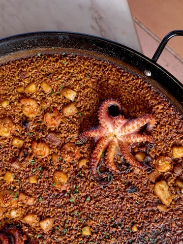 a pan of food with octopus on top