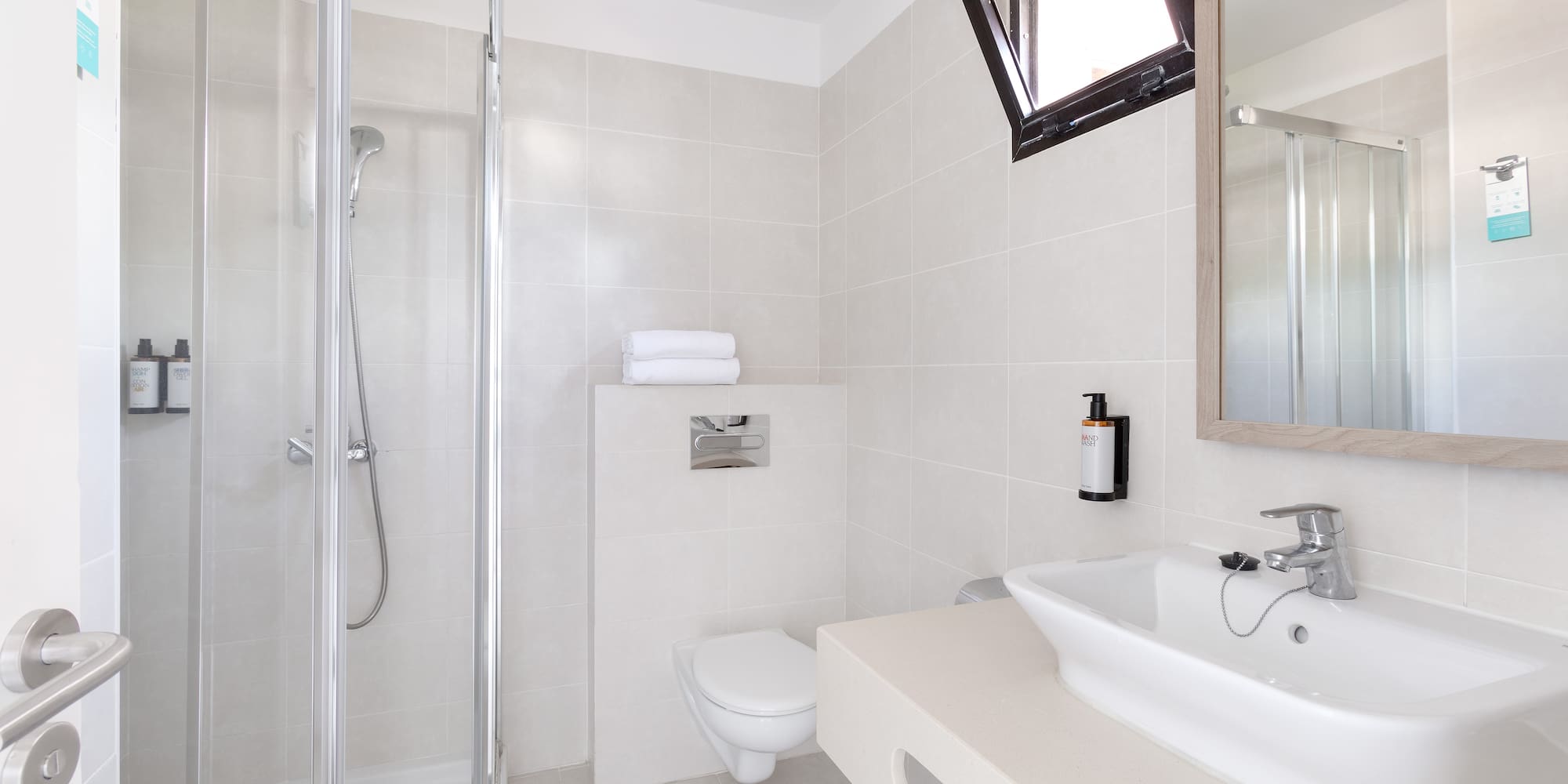 a bathroom with a shower and sink