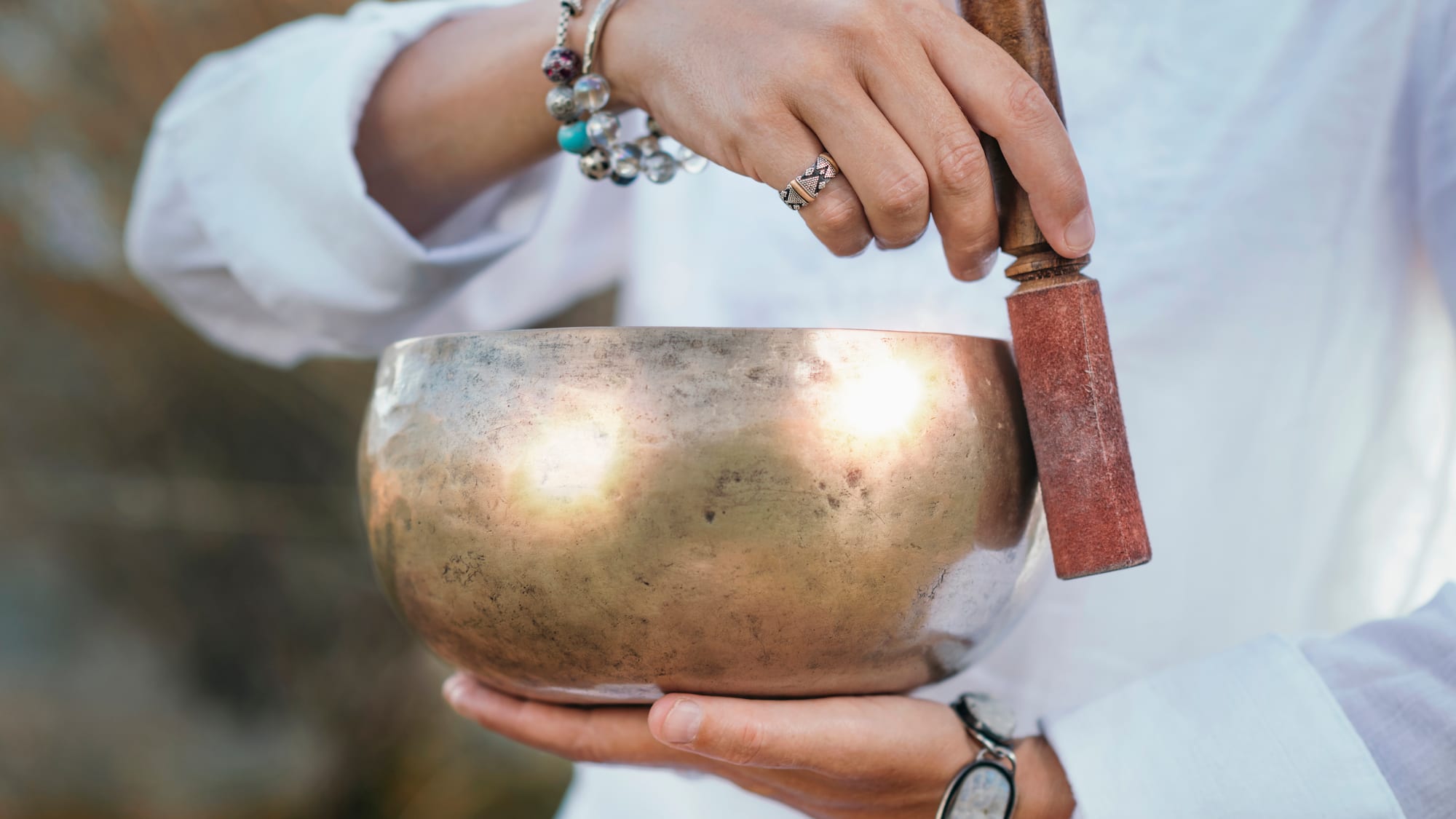 a person holding a singing bowl