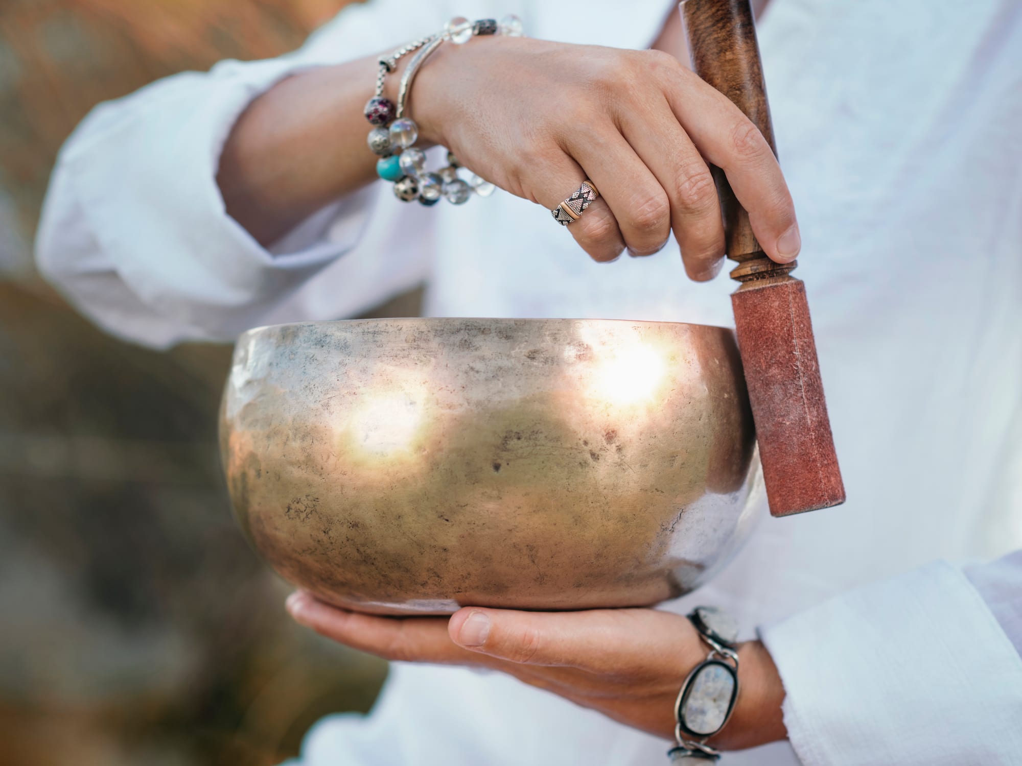 a person holding a singing bowl
