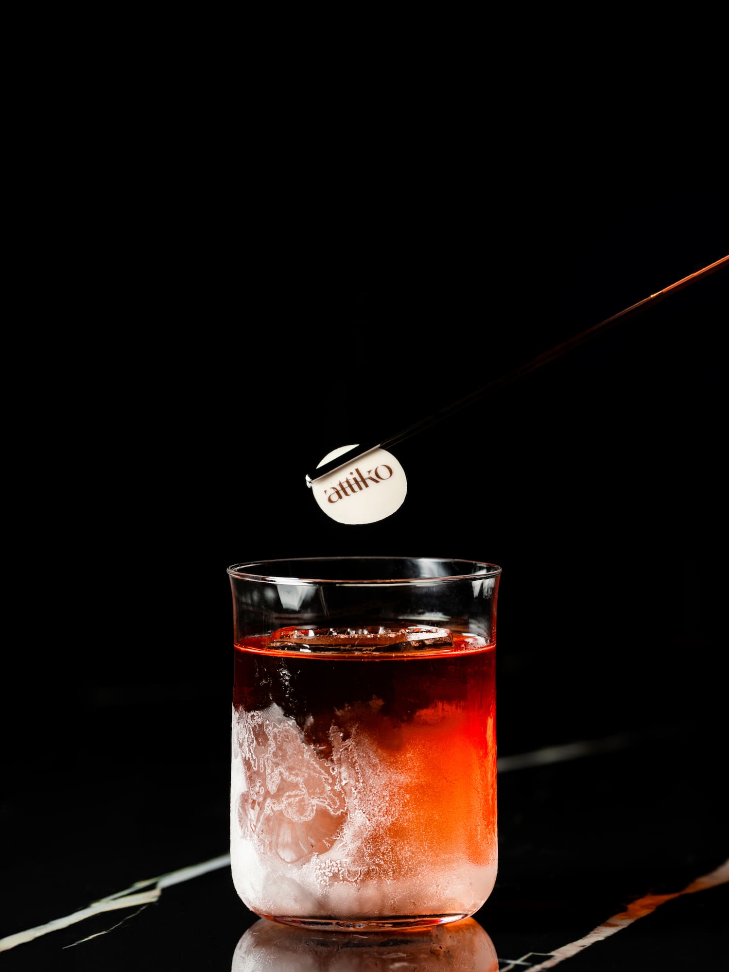 a stick sticking out of a glass of liquid