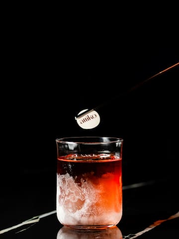 a stick sticking out of a glass of liquid
