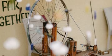 a bicycle wheel on a wooden stand