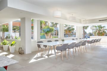 a room with a long table and chairs