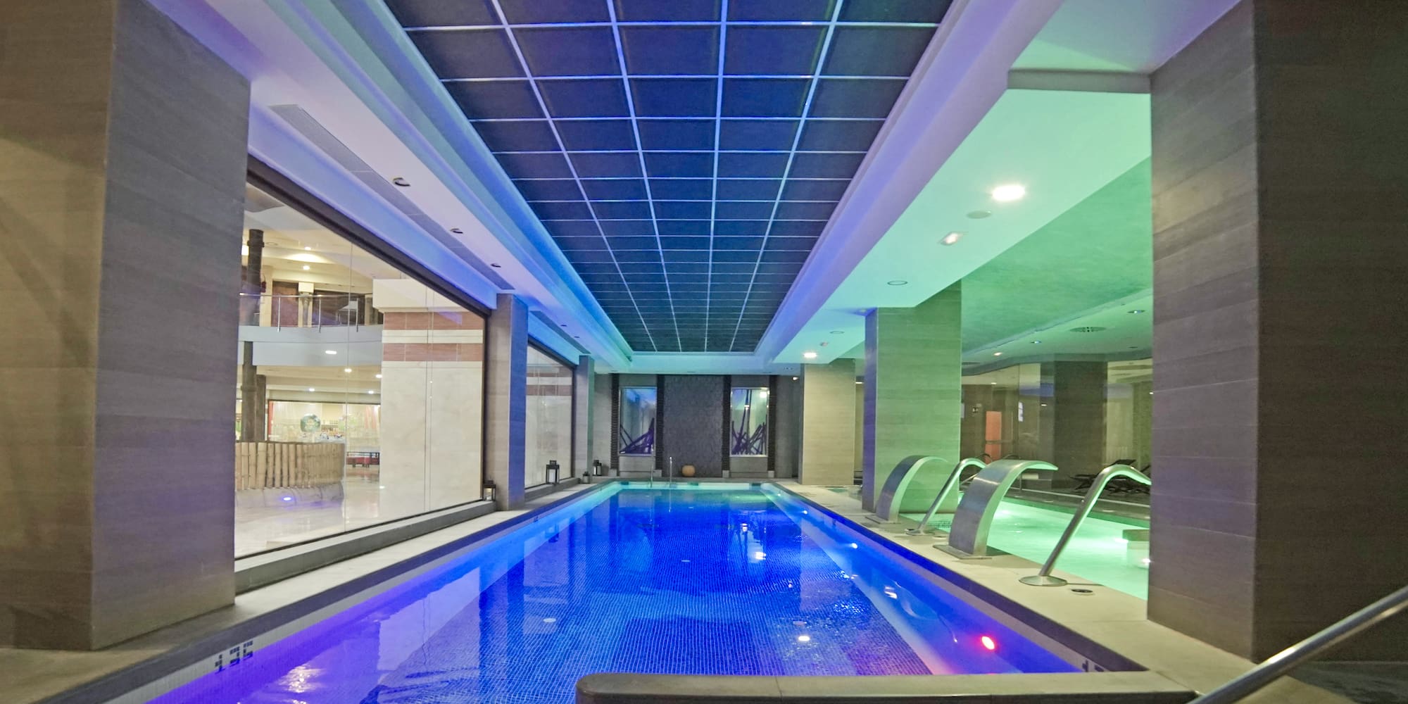 a indoor pool with a large tub