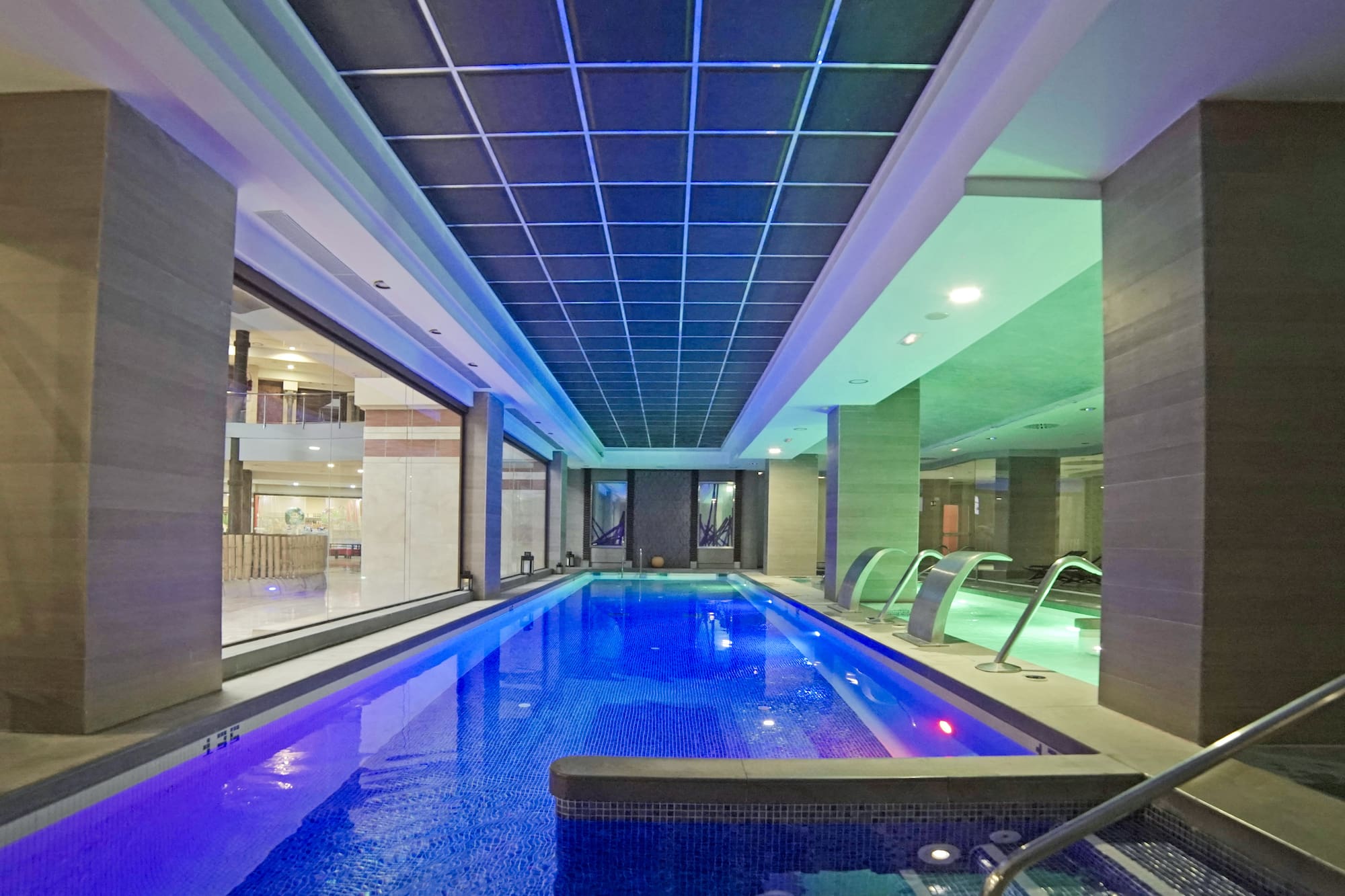 a indoor pool with a large tub