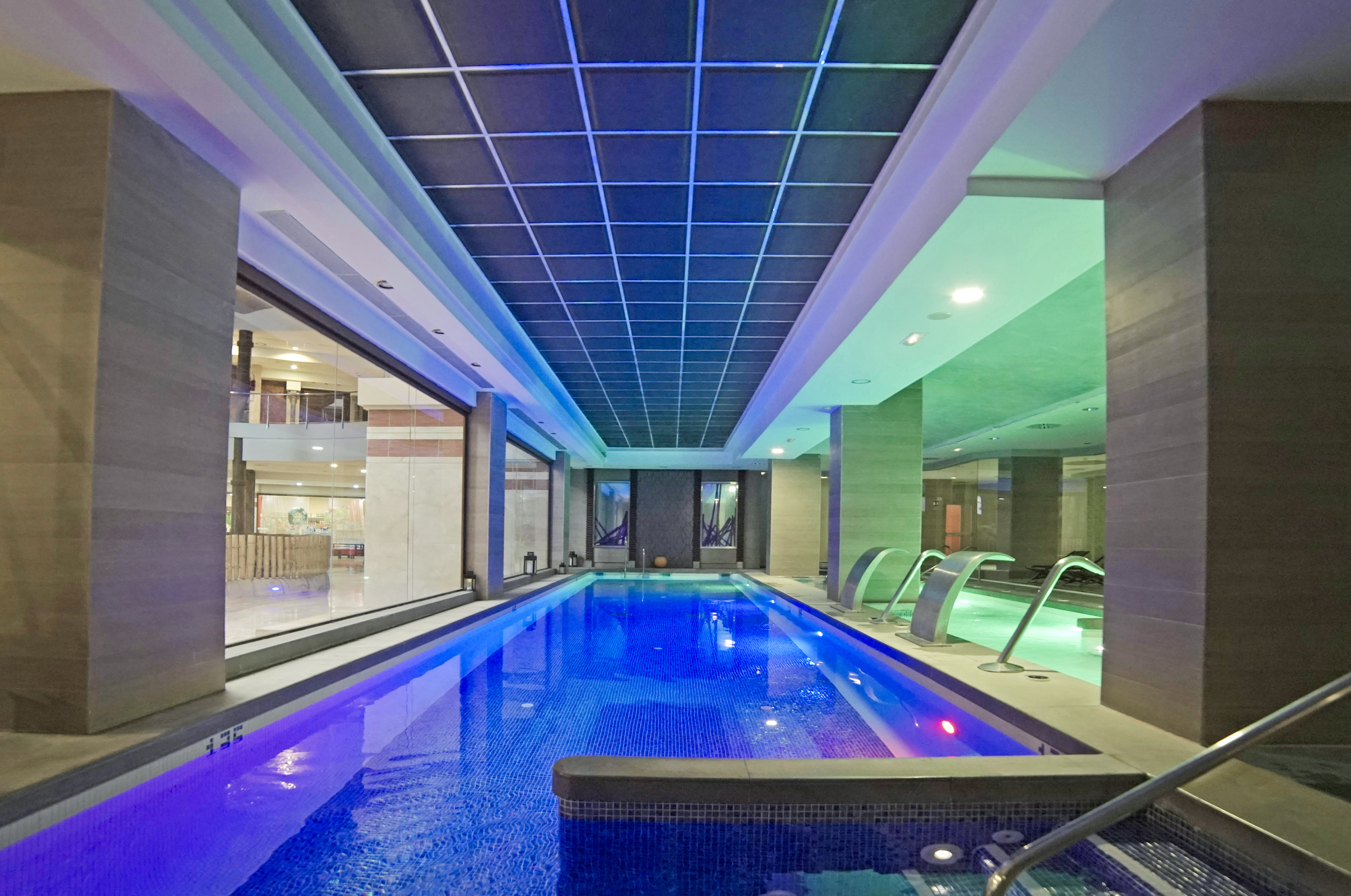 a indoor pool with a large tub