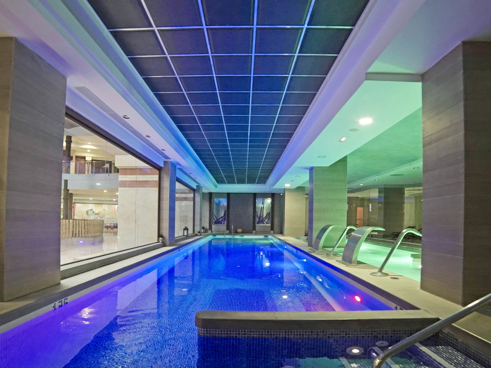 a indoor pool with a large tub