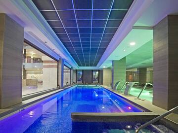 a indoor pool with a large tub