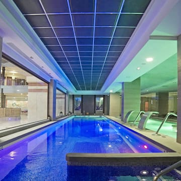 a indoor pool with a large tub