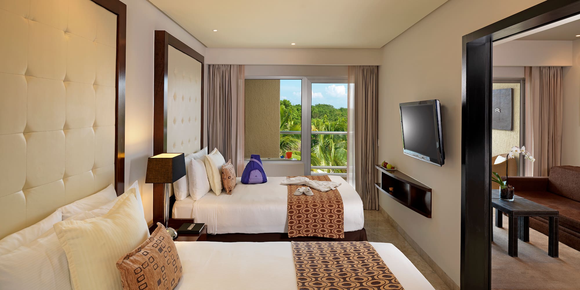 a room with two beds and a television