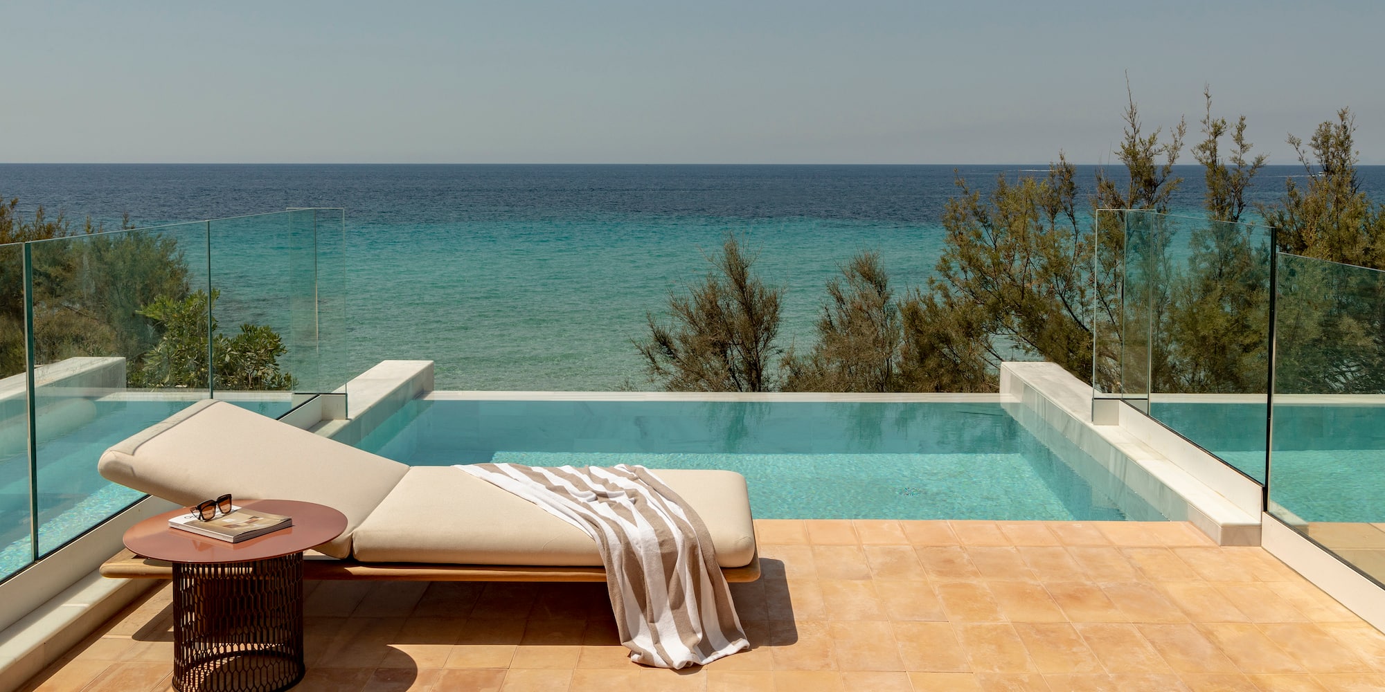 a pool with a lounge chair and a table