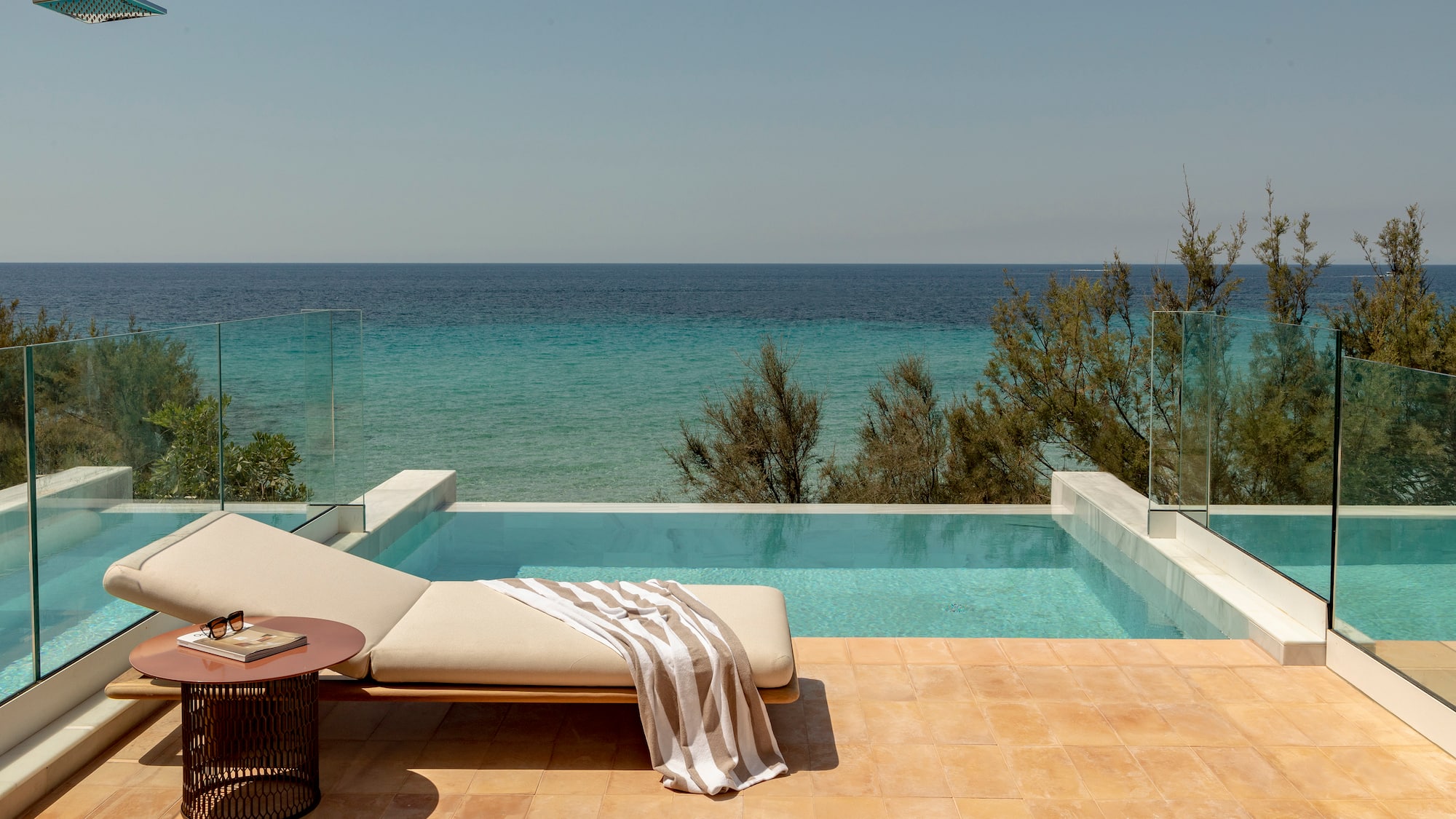 a pool with a lounge chair and a table