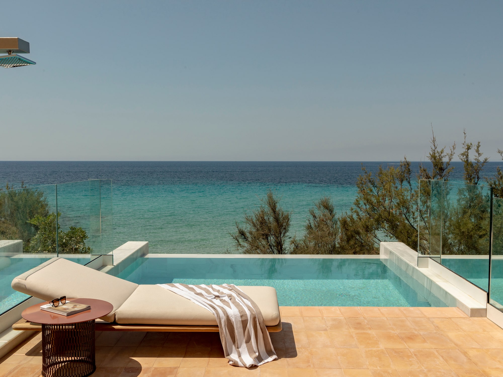 a pool with a lounge chair and a table