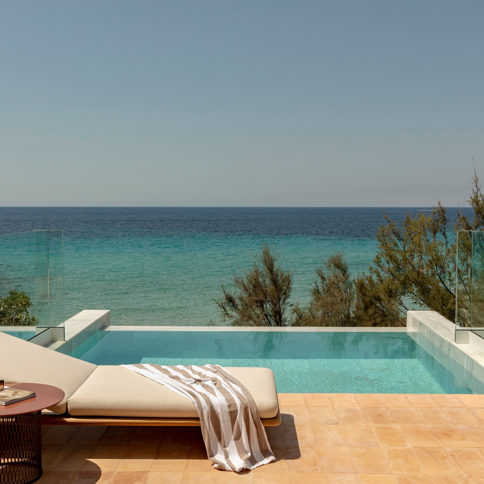a pool with a lounge chair and a table