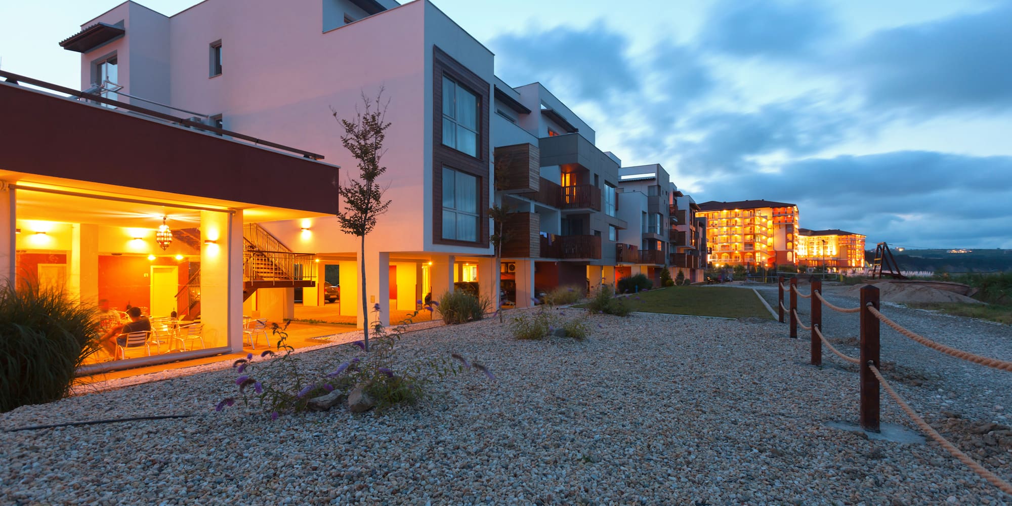 a group of buildings with a gravel path
