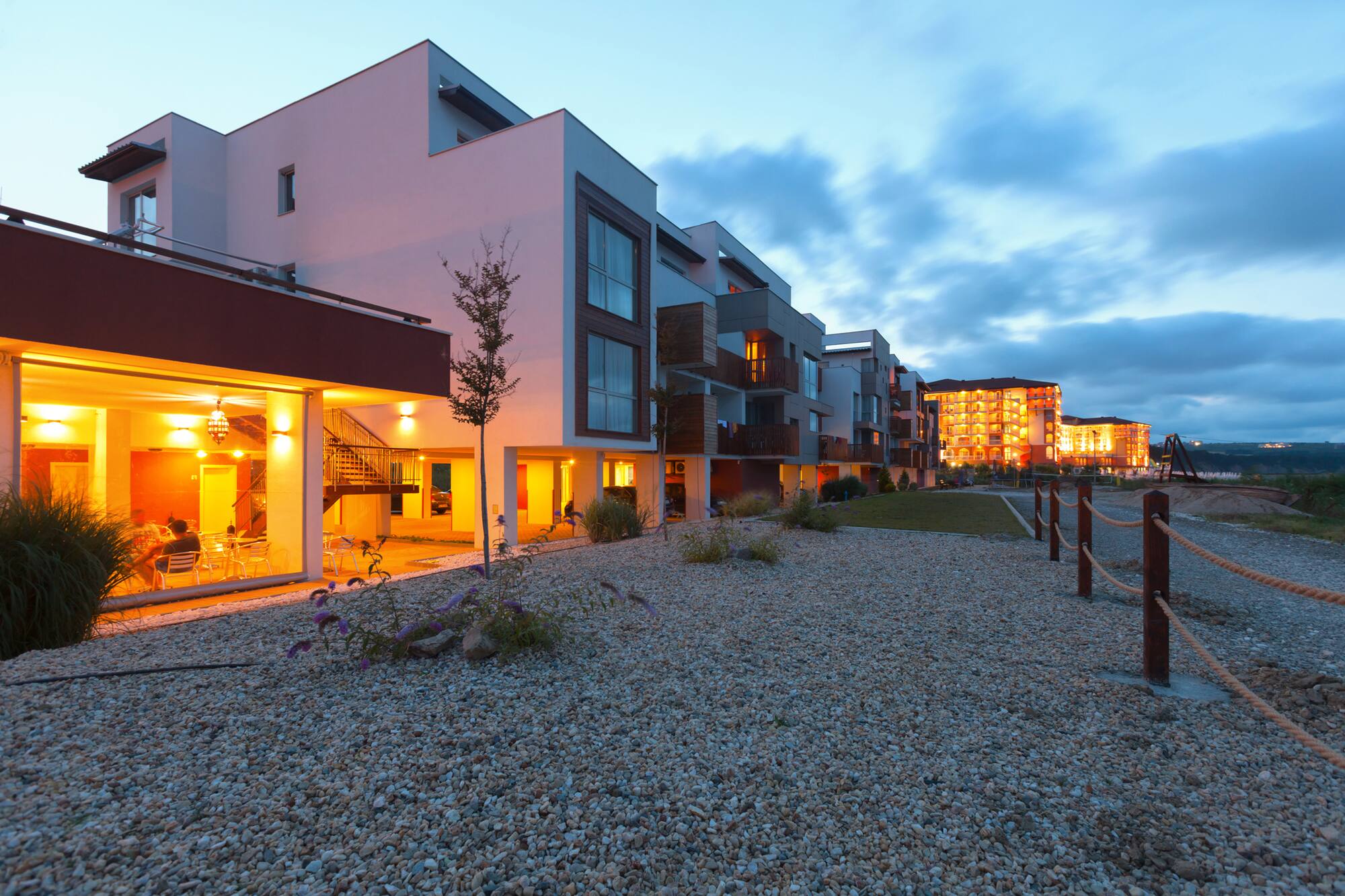 a group of buildings with a gravel path