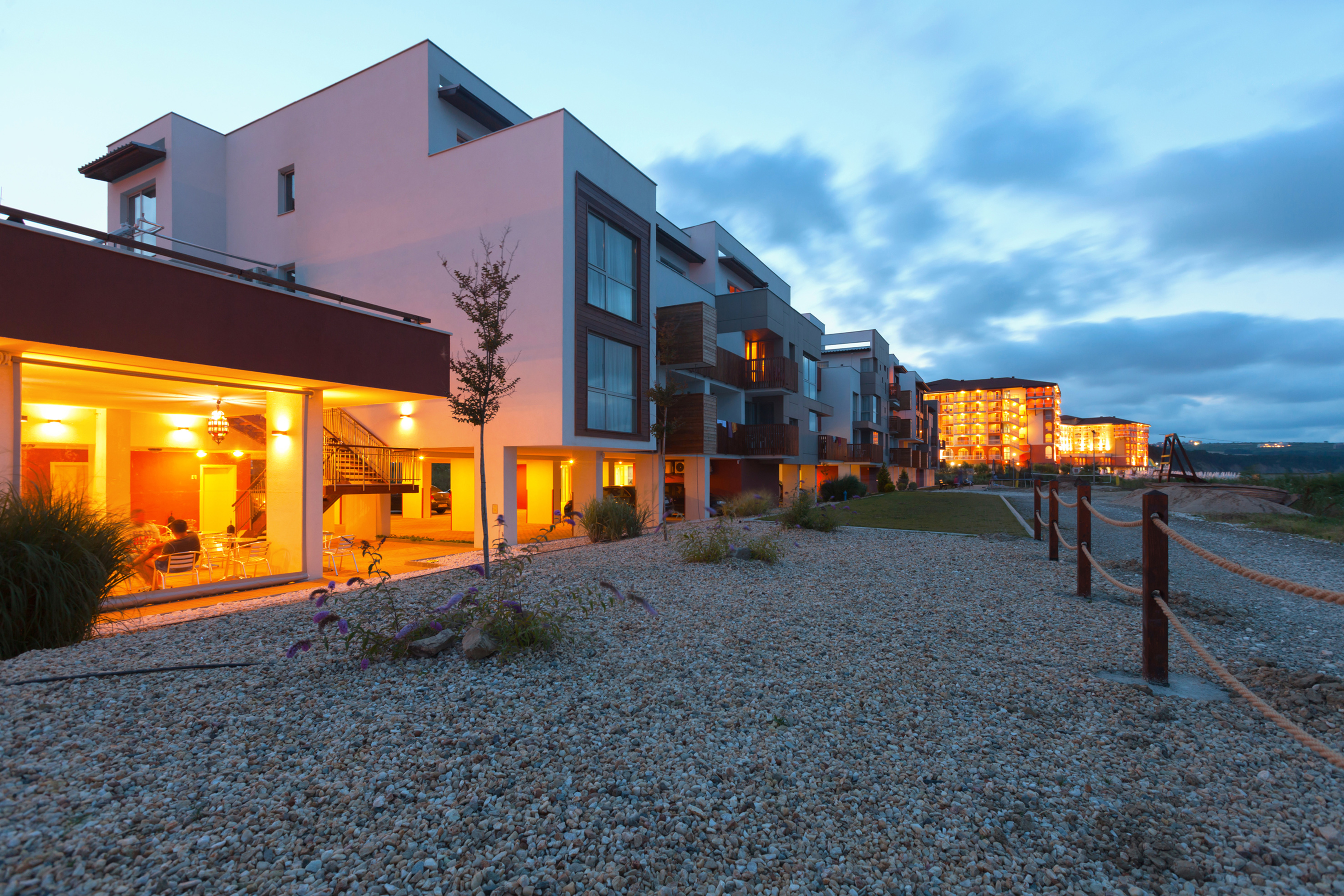 a group of buildings with a gravel path