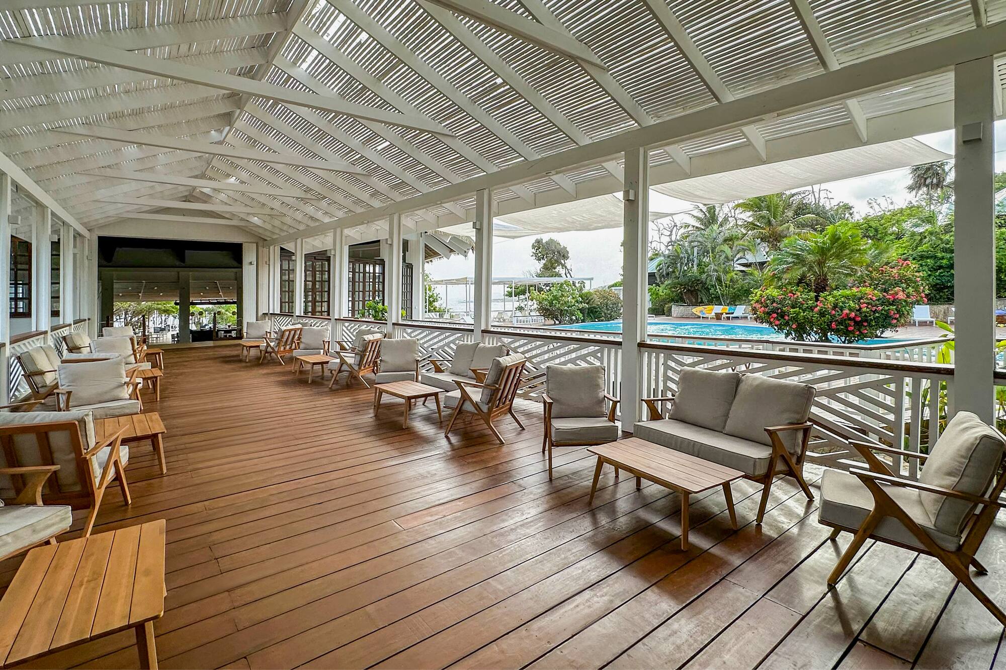 a patio with chairs and a pool
