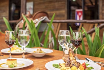 a table with plates of food and wine glasses