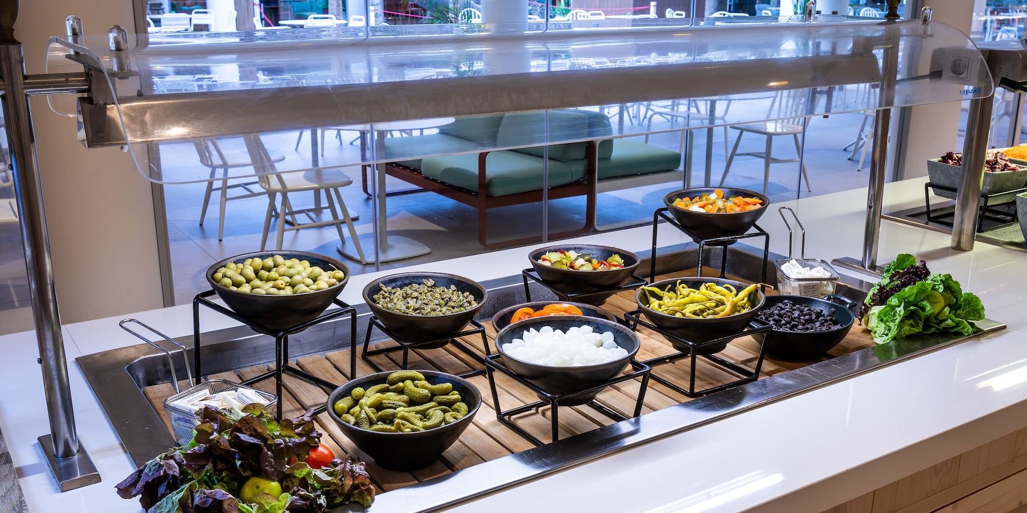 a buffet table with bowls of food