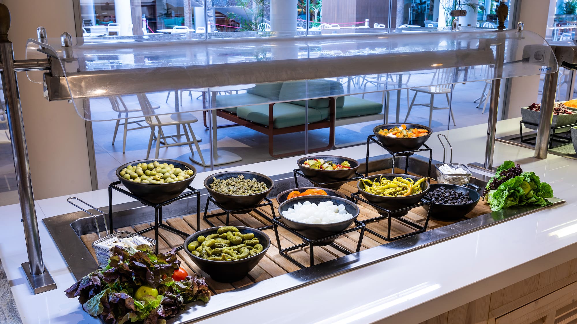 a buffet table with bowls of food