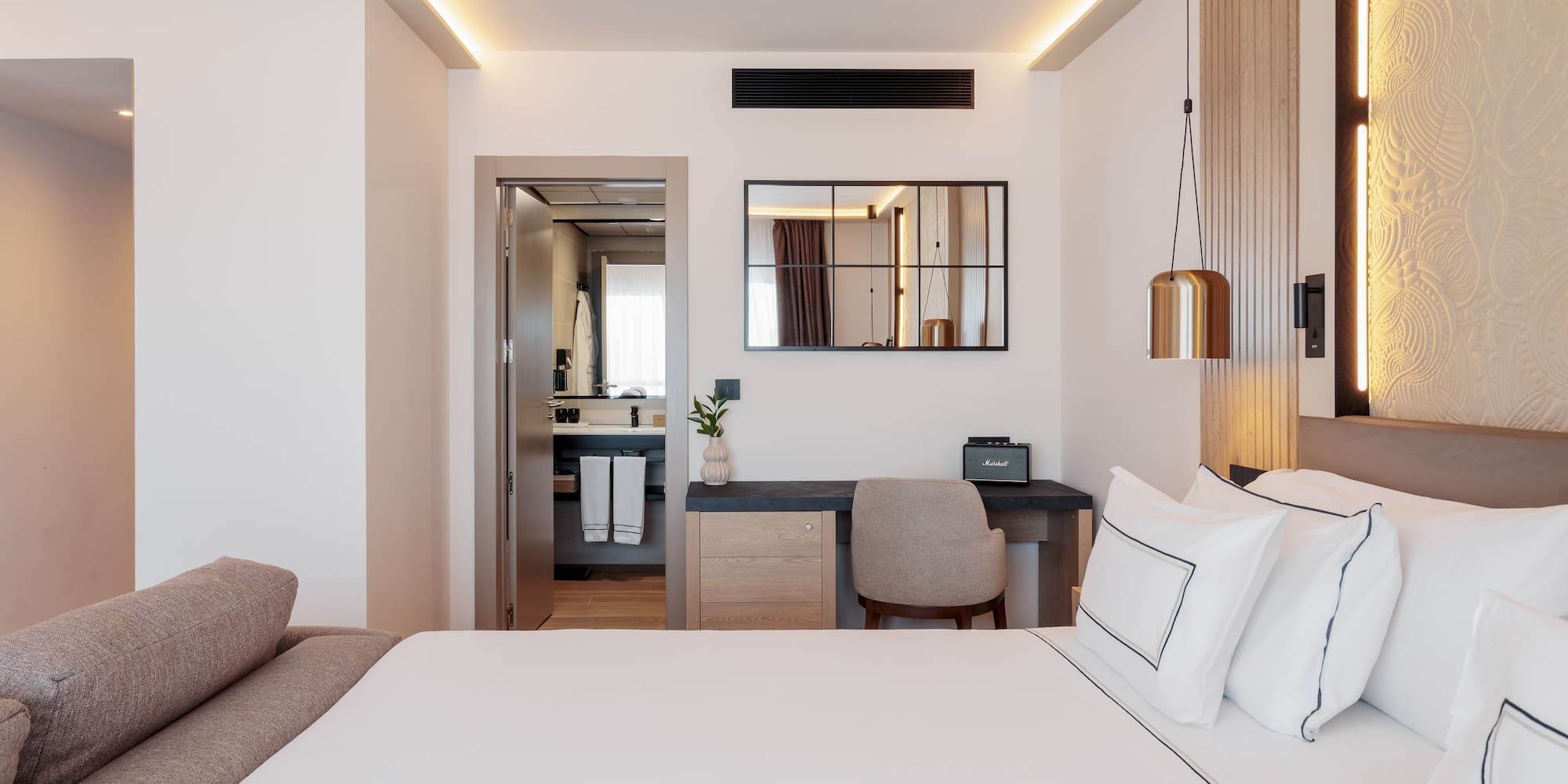 a bedroom with a bed and a mirror