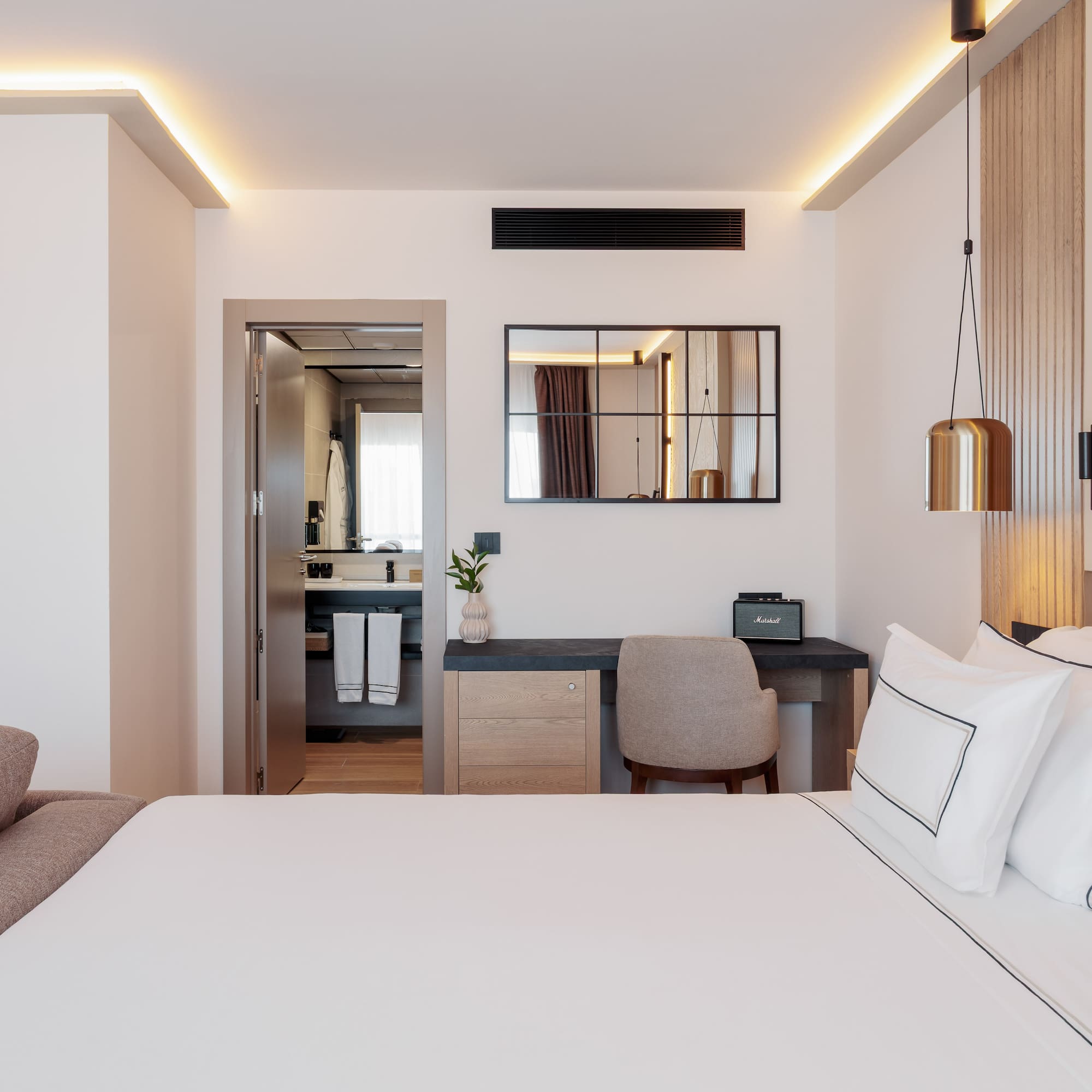 a bedroom with a bed and a mirror