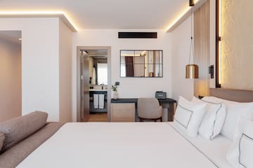 a bedroom with a bed and a mirror