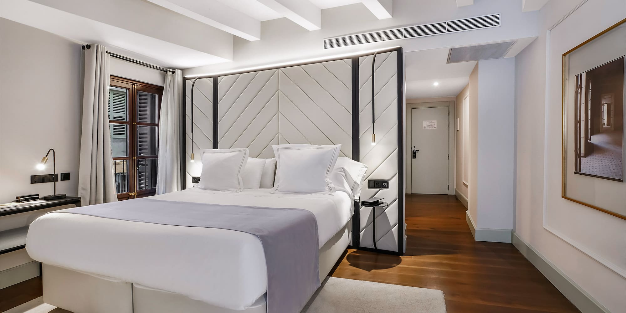 a bedroom with a bed and a wood floor