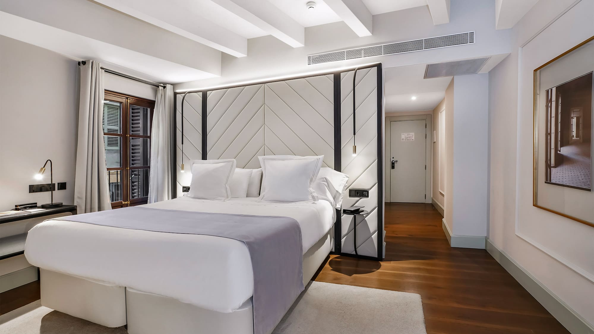 a bedroom with a bed and a wood floor