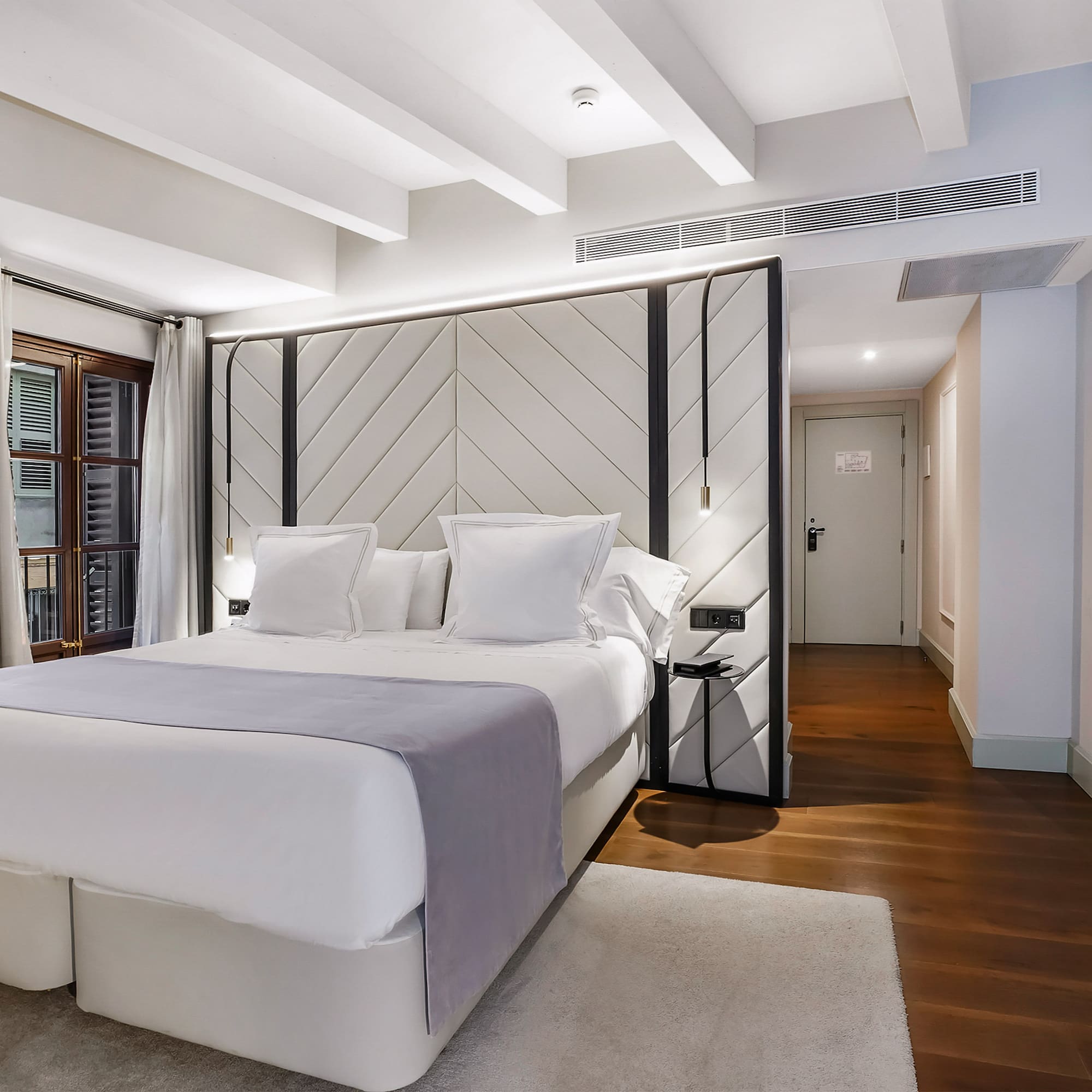 a bedroom with a bed and a wood floor