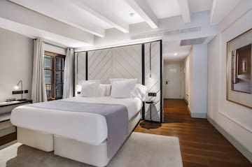 a bedroom with a bed and a wood floor